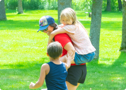 Children playing with North Homes staff member